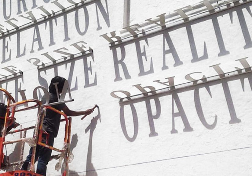 Typographic Shadow Graffiti Turns Boring Building Into Ever Changing Masterpiece